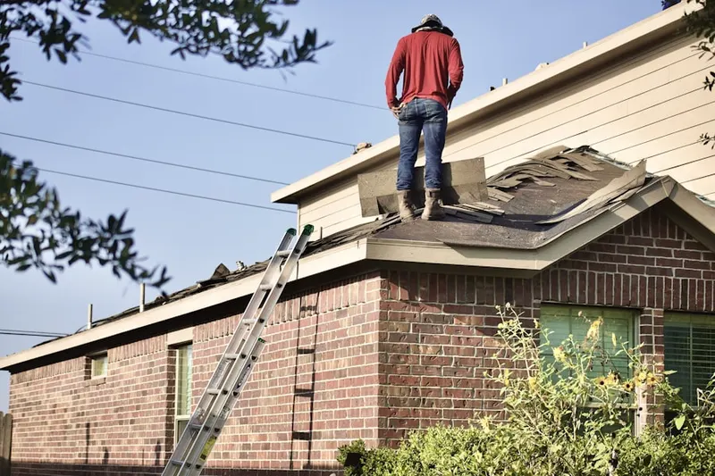 Professional roofer working on a residential roof in Century Gardens Villas